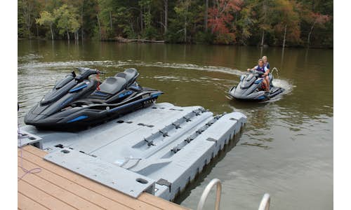 Photo of two Permaport Xpress drive-on PWC ports mounted side-by-side with jet ski about to drive on